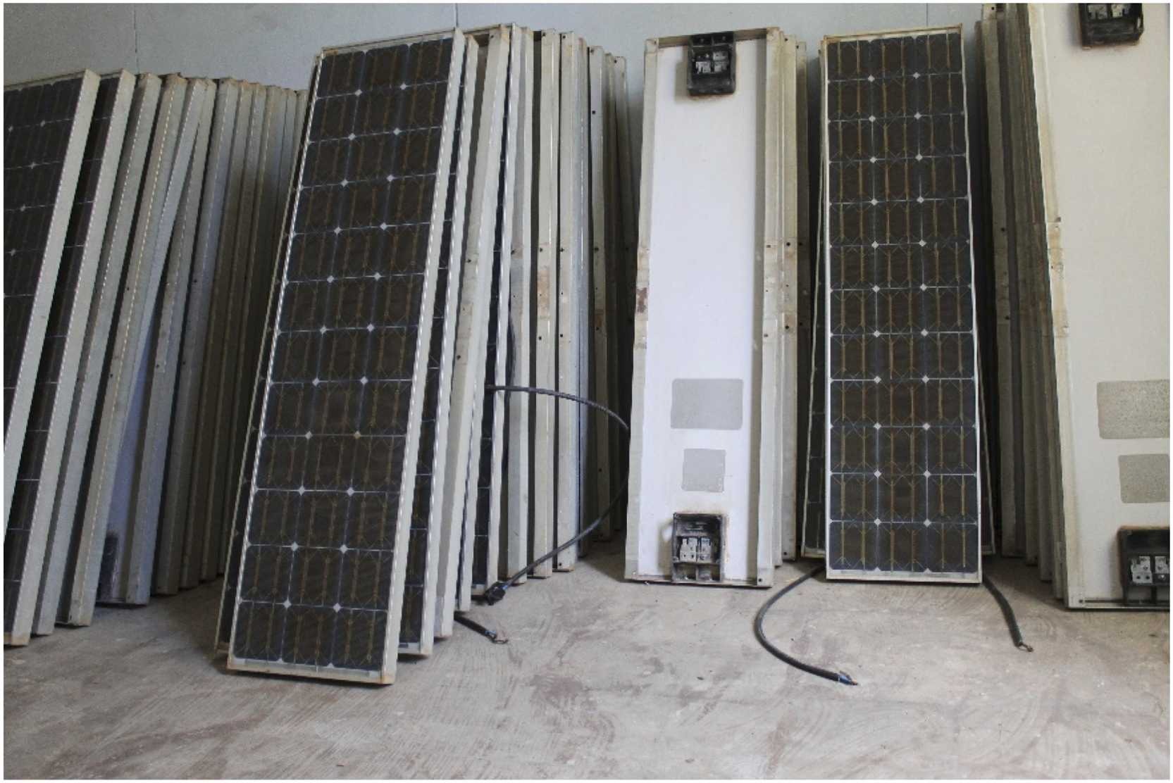 Stack of vintage Arco Solar photovoltaic modules at CDER in Algiers