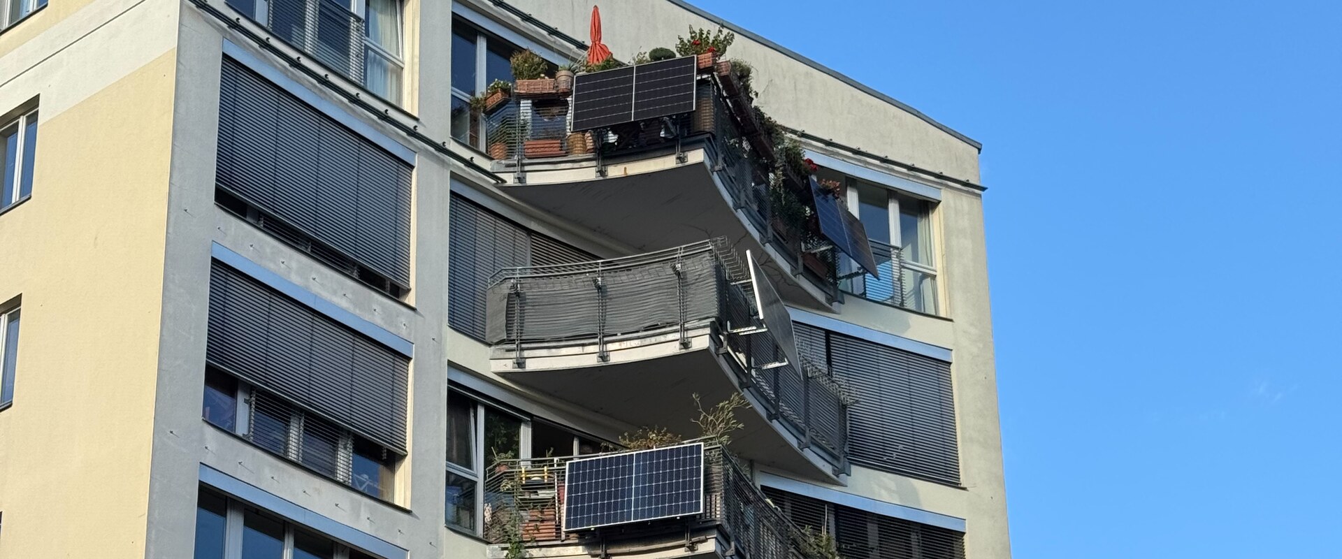 Apartment balconies with plug-in solar panels on a Berlin residential building